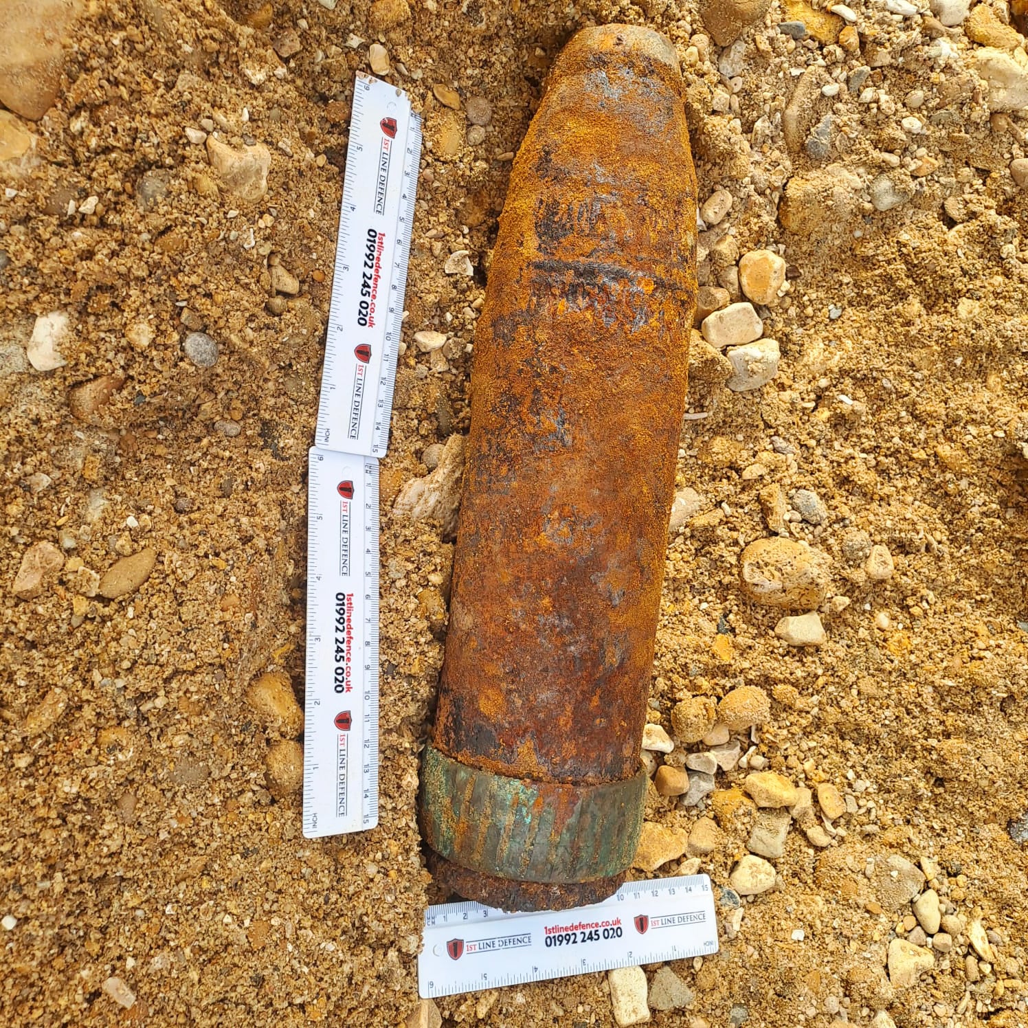 Anti-aircraft Projectile (with rulers for scale) which was discovered on a development site in Southampton by 1st Line Defence.